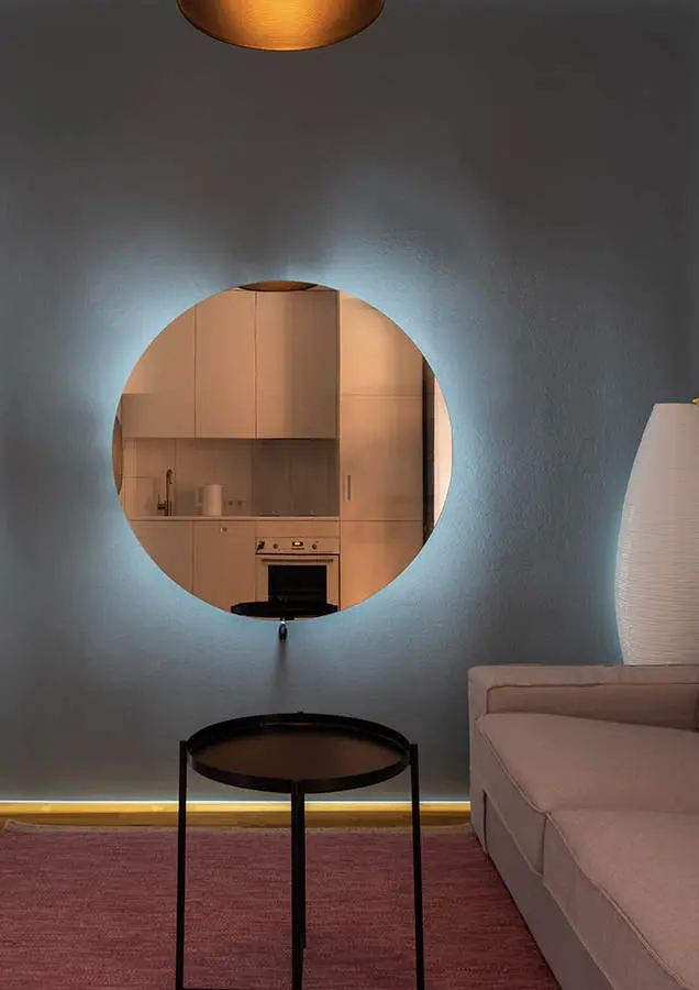 Living room decorated with round mirror