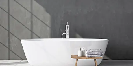 Bathroom with freestanding bathtub and microcement wall