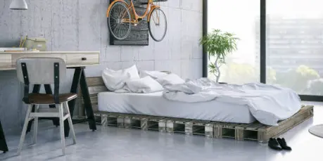 Camera da letto con pavimento in microcemento grigio